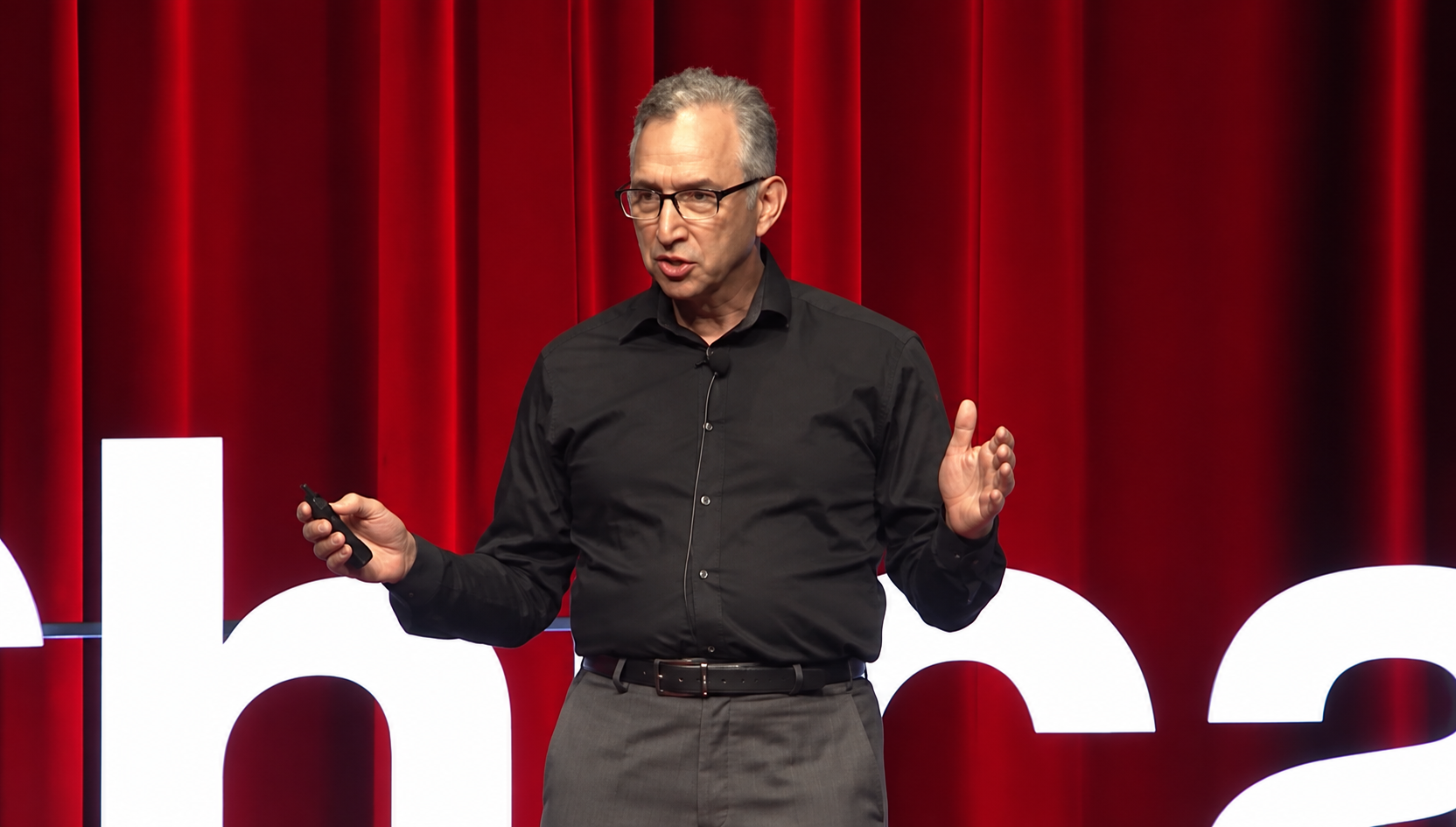 David Ansell speaking on a TED stage